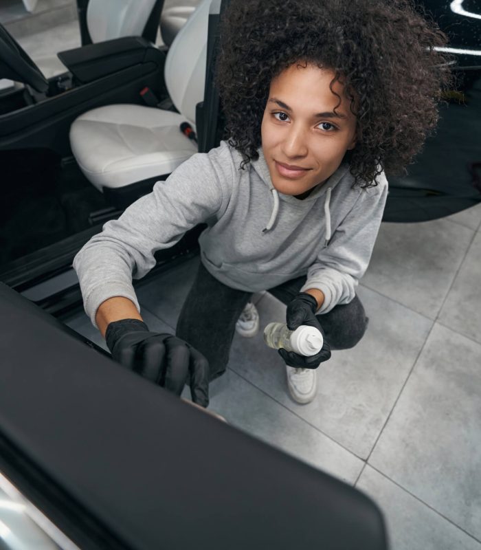pleased-auto-detailer-brushing-car-door-panel.jpg