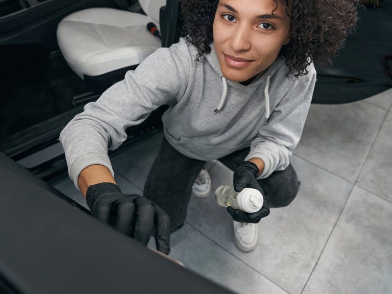 pleased-auto-detailer-brushing-car-door-panel.jpg
