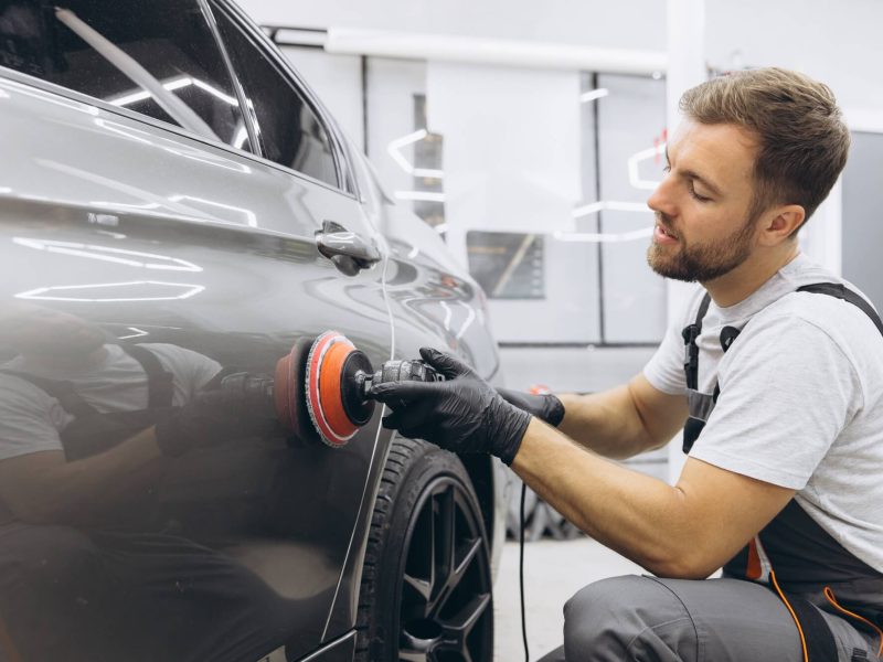 professional-car-detailing-with-an-auto-polisher-in-a-garage-setting.jpg
